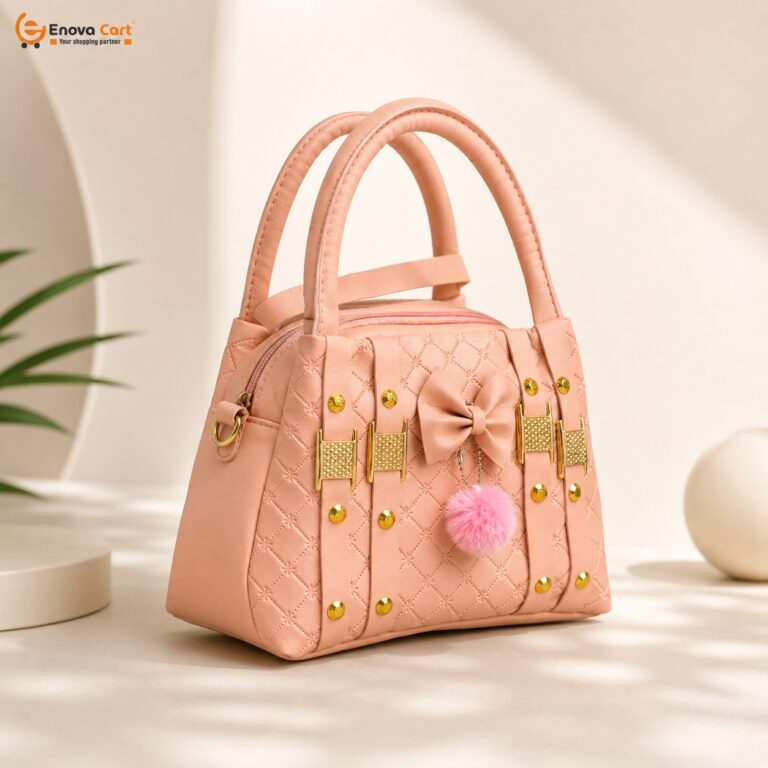 Elegant structured peach pink quilted leather tote handbag for women featuring gold-tone metal studs, a decorative pink silk bow, and a fuzzy pink pom-pom charm on a clean minimalist display stand